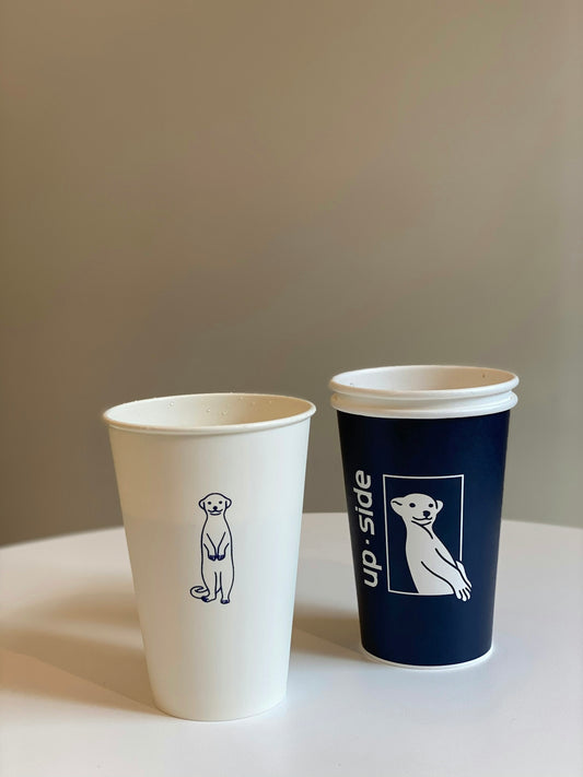 two white and black disposable cups